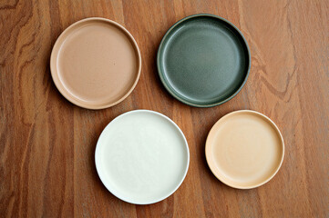 Nature-inspired round plates on rustic wooden background