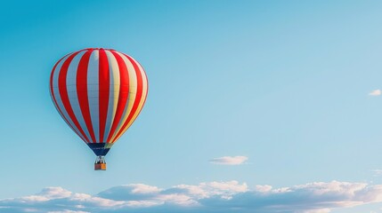 Fototapeta premium Hot air balloon soaring in a clear blue sky during daylight with clouds in the background