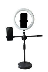 Round LED ring light with a cellphone on a phone holder isolated over a white background. Vlogging or live streaming equipment. Mockup or Copy space