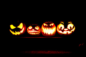 pumpkin carving halloween jack-o'-lanterns glowing in the dark - 