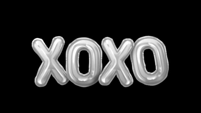 X and O shaped balloon decoration floating isolated on black background