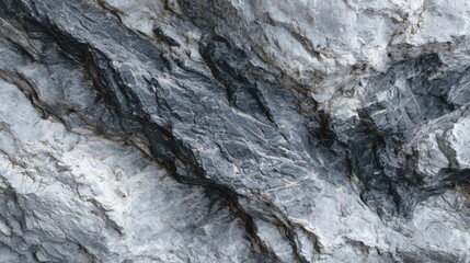 Textured gray rock surface showing mineral veins in natural formation
