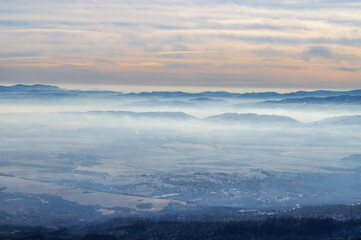 Foggy Mountain Valley at Dawn with Soft Pastel Sky
