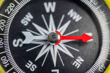 Closeup view of navigational compass on black background. Travel guidance equipment