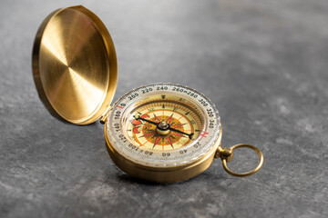Closeup view of navigational compass on black background. Travel guidance equipment