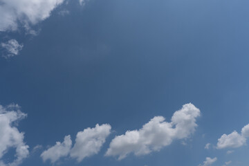 a row of clouds in the blue sky