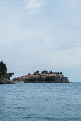 Sveti Stefan private island in Montenegro near Budva. Adriatic Sea Coast travel destination vacation holiday idea. Concept of getting away tourism experiences. Nature driven scenery wanderlust vibes