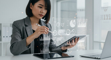 Asian woman analyzing financial data on a futuristic holographic interface