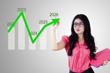 Businesswoman Drawing Growth Chart from 2021 to 2026 – Future Planning and Market Analysis Concept