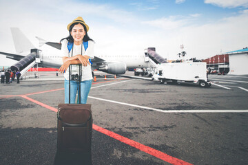 Young Woman Traveler at Airport with Luggage and Camera Ready to Board
