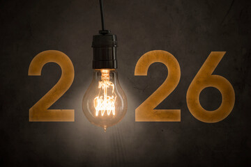 2026 Year Concept with Glowing Vintage Light Bulb on Dark Background