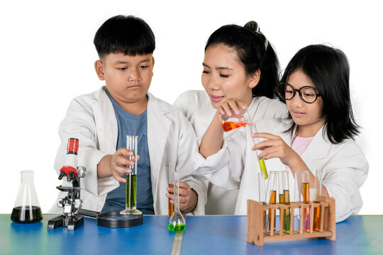 Asian Teacher Supervising Students Mixing Chemicals in Science Laboratory - Powered by Adobe