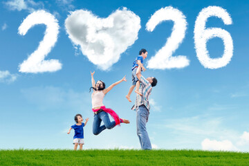 Happy Family Outdoors with 2026 and Heart Cloud in Blue Sky
