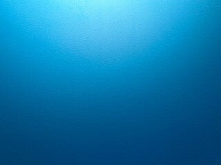 Blue textured wall with a rough and uneven surface. Design element