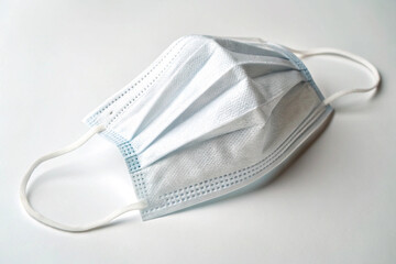 Protective face covering: a common blue surgical mask, photographed for educational or retail use