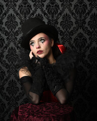 Close-up  glamour portrait of circus burlesque model wearing top hat and gothic gloves, theatrical...