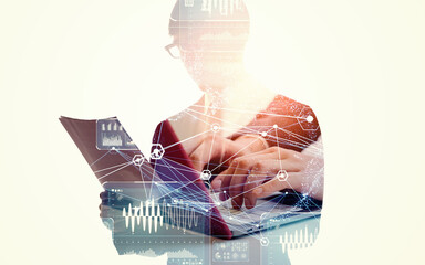 Silhouette of a man using a PC and a collage of digital technology images. Wide angle visual for...