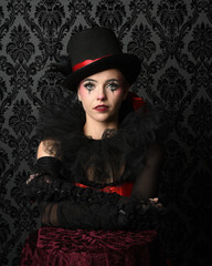 Close-up  glamour portrait of circus burlesque model wearing top hat and gothic gloves, theatrical...