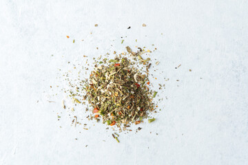 pile of mixed dried herbs on white background