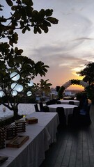 Rooftop Pool and Elegant Dining Setup with Glowing Lanterns at Twilight