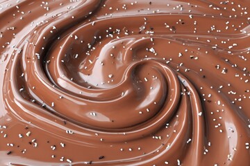 Silky, warm brown caramel swirls create a smooth, glossy texture, enhanced with tiny sprinkles adding a touch of elegance