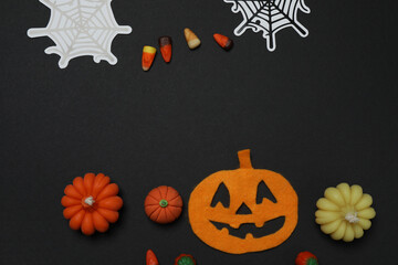 Halloween with skull, ticks, orange maple leaves, bats, spiders on black background with space for...