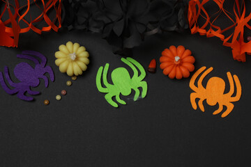 Halloween with skull, ticks, orange maple leaves, bats, spiders on black background with space for...
