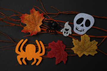 Halloween with skull, ticks, orange maple leaves, bats, spiders on black background with space for...