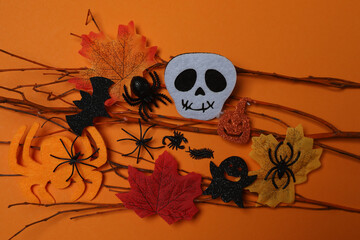 Halloween with skull, ticks, orange maple leaves, bats, spiders on black background with space for...