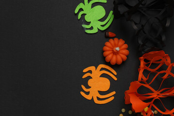 Halloween with skull, ticks, orange maple leaves, bats, spiders on black background with space for...