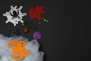 Halloween with skull, ticks, orange maple leaves, bats, spiders on black background with space for...