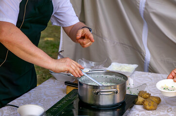 Traditional Polish gzik made of cottage cheese and sour cream, prepared outdoors and served with...