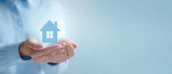 The house symbol held securely in hands representing homeownership and safety