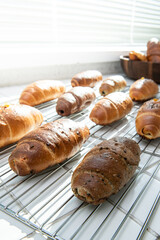 Freshly Baked Croissants and Rolls on a Cooling Rack