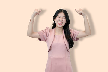Naklejka premium Young Asian Woman Flexing Biceps, Showing Strength 