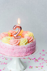 Celebrate a second birthday with a colorful cake and festive decorations