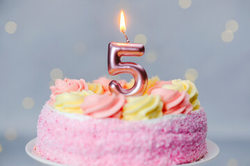 Celebrate a special birthday with a pink cake and number candle