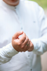 Person demonstrating a hand gesture in a natural setting during daylight