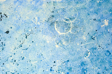 Abstract blue painting with circular shapes and splatter patterns