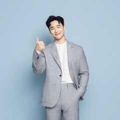 Confident Young Asian Businessman Giving Thumbs Up in a Studio Generating AI
