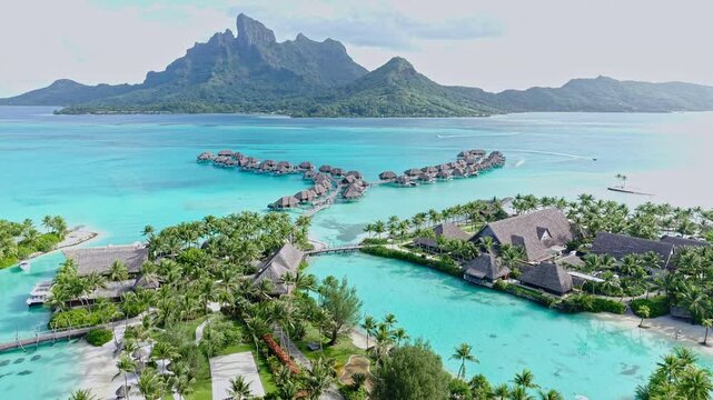 Bora Bora, French Polynesia. Aerial View of Luxury Resort and Overwater Bungalows Overlooking Lagoon and Main Island
