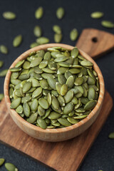 Pumpkin seeds in wooden bowl