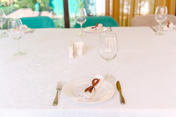 Elegant dining setup for a special event in a bright venue with natural light