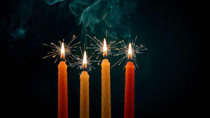 Sparkling teal and orange candles with ethereal smoke