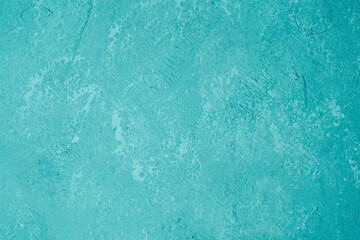 Bright turquoise stucco wall with textured plaster and modern finish