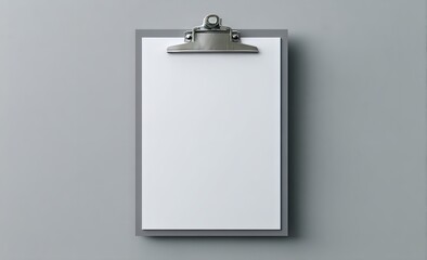 A blank white sheet of paper is clipped onto a grey clipboard, set against a muted grey backdrop