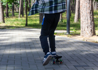 child riding a steak in the park, skateboarding, summer vacation in the park, boy riding a...