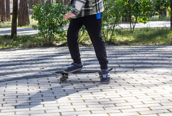 child riding a steak in the park, skateboarding, summer vacation in the park, boy riding a...