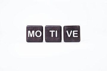 The concept word MOTIVE is assembled from wooden cubes. business motivational concept