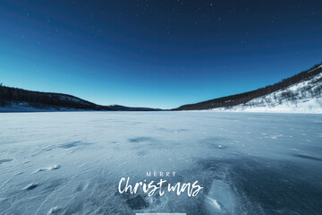 Vast frozen lake under starry night sky, serene winter landscape